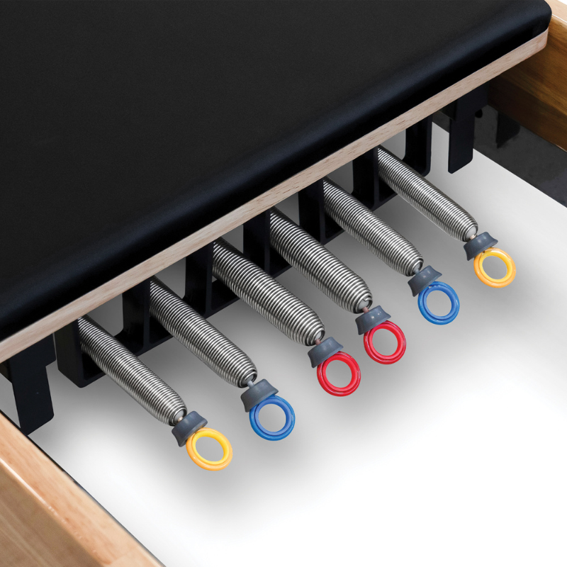 Close-up of the springs on the Impact Fitness Oak Wood Pilates Reformer Machine