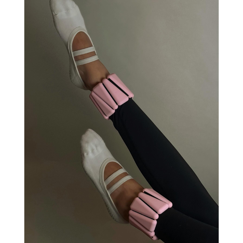 closer view of woman's legs wearing levaïa weights for the ankle in classic blush