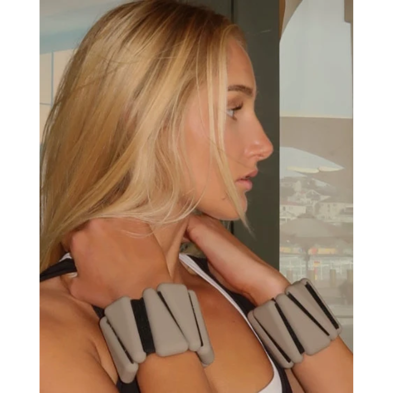 closer view of woman wearing levaïa wrist weights in classic taupe