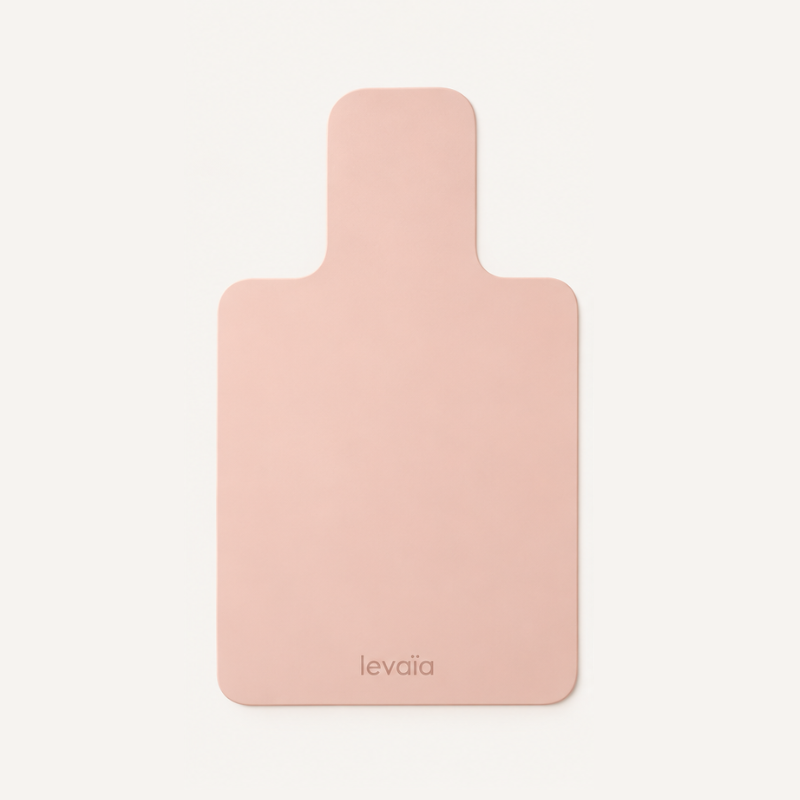 levaïa Pilates Reformer Mat in Blush laid flat, with rounded corners, a narrow headrest extension and the levaïa logo near the bottom.
