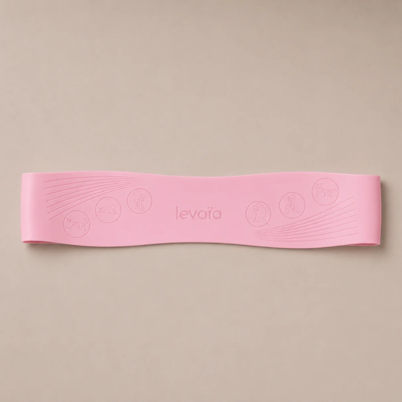 levaïa Pilates resistance band in Blush lying flat on a beige background, with an embossed logo