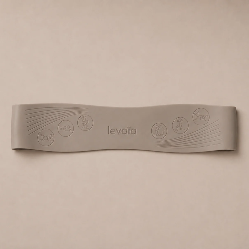 levaïa Pilates resistance band in Taupe lying flat on a beige background, with an embossed logo