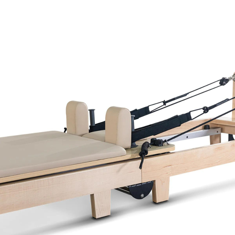 Closer view of the carriage, ropes and straps on the Lifespan Fitness Contour Folding Wooden Pilates Reformer Machine in Beige