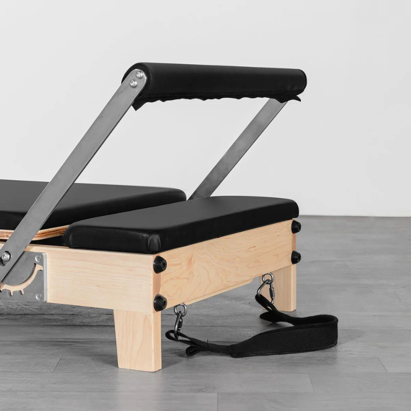 Close-up of the foot bar on the Lifespan Fitness Contour Folding Wooden Pilates Reformer Machine in Black