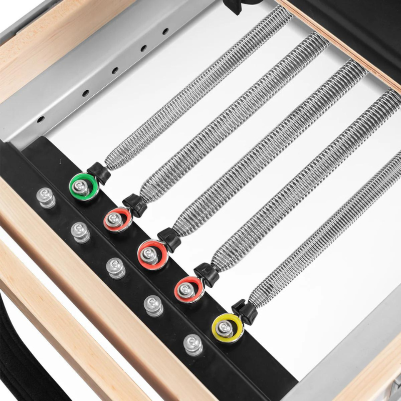 Close-up of the springs on the Lifespan Fitness Contour Folding Wooden Pilates Reformer Machine in Black