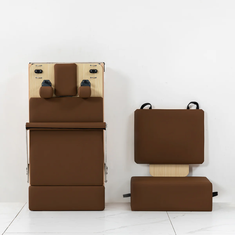 Front view of the Lifespan Fitness Contour Folding Wooden Pilates Reformer Machine in Espresso colour  with jumpboard and sitting box next to it