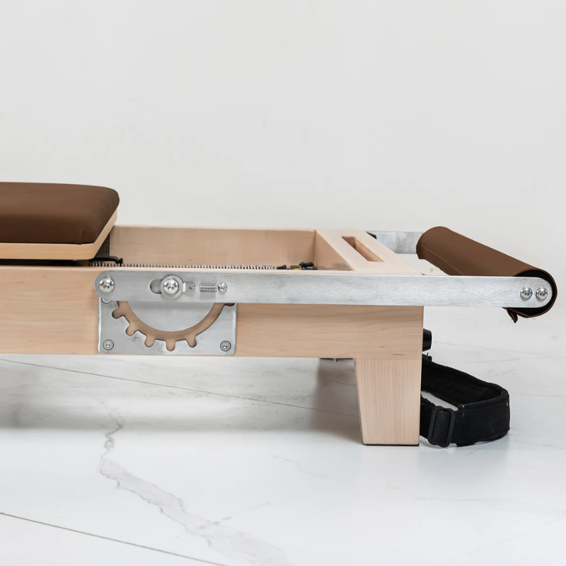 Close-up of the footbar folded down on the Lifespan Fitness Contour Folding Wooden Pilates Reformer Machine in Espresso