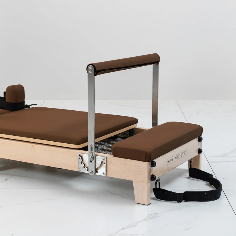 Close-up of the footbar and standing platform on the Lifespan Fitness Contour Folding Wooden Pilates Reformer Machine in Espresso