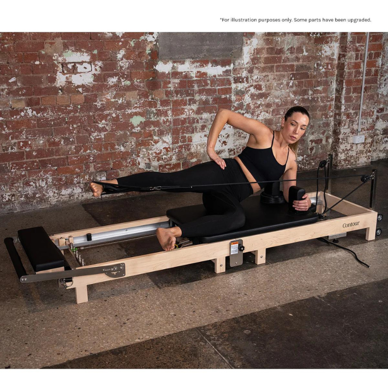 A woman exercising on the Lifespan Fitness Contour Folding Wooden Pilates Reformer Machine in Black