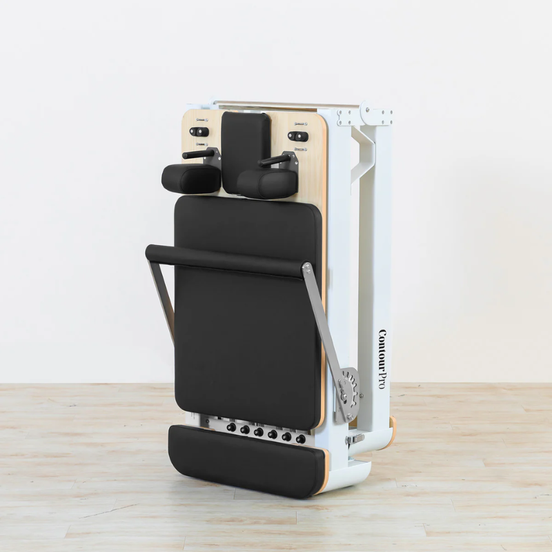 Side angled view of the Lifespan Fitness Contour Pro Folding Pilates Reformer folded upright.