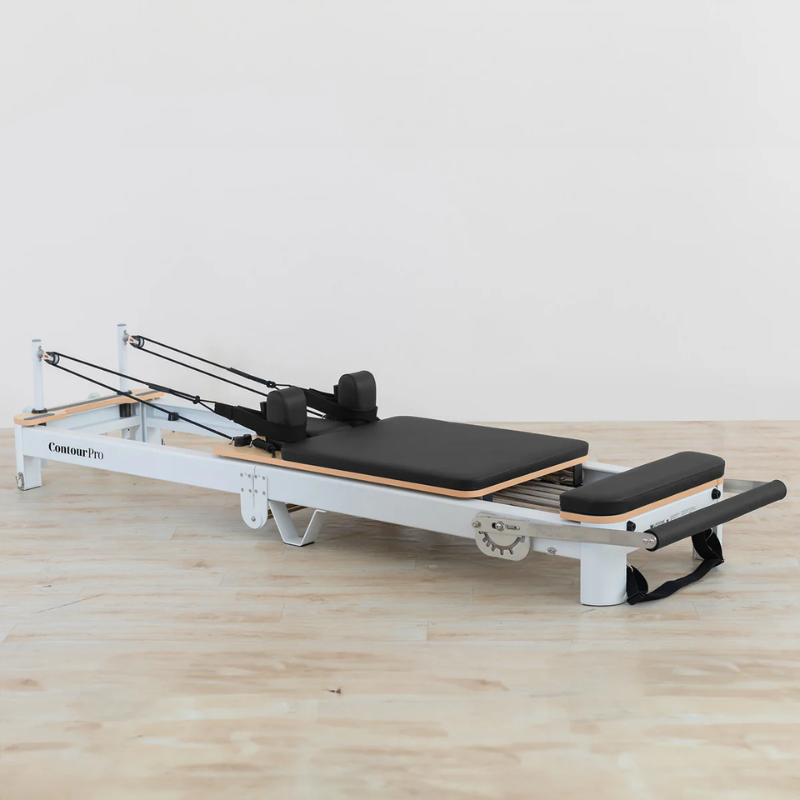 Lifespan Fitness Contour Pro Folding Pilates Reformer with the footbar folded down inside a studio