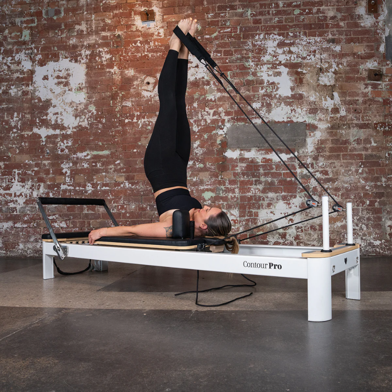 Woman exercising on the Lifespan Fitness Contour Pro Aluminium Pilates Reformer Machine in Black