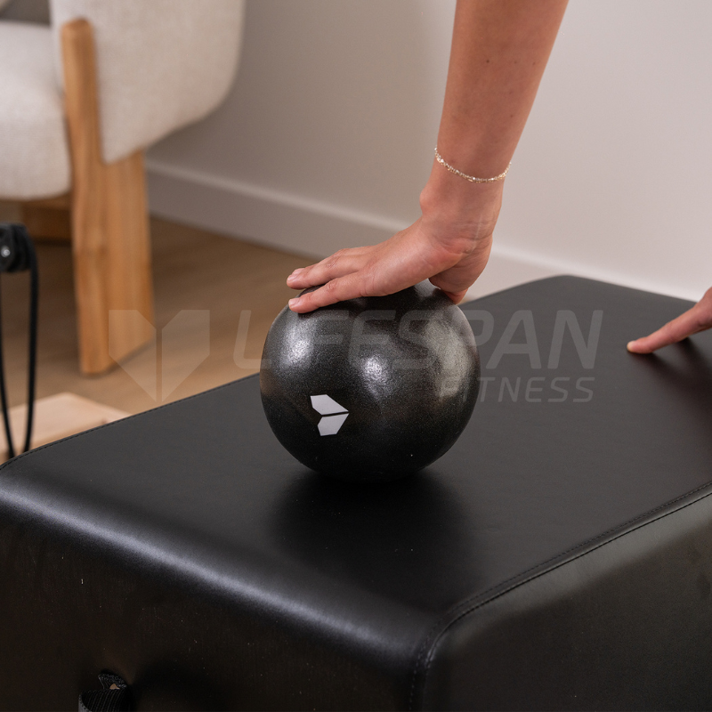 Woman's hand resting on a Lifespan Fitness Pilates Ball