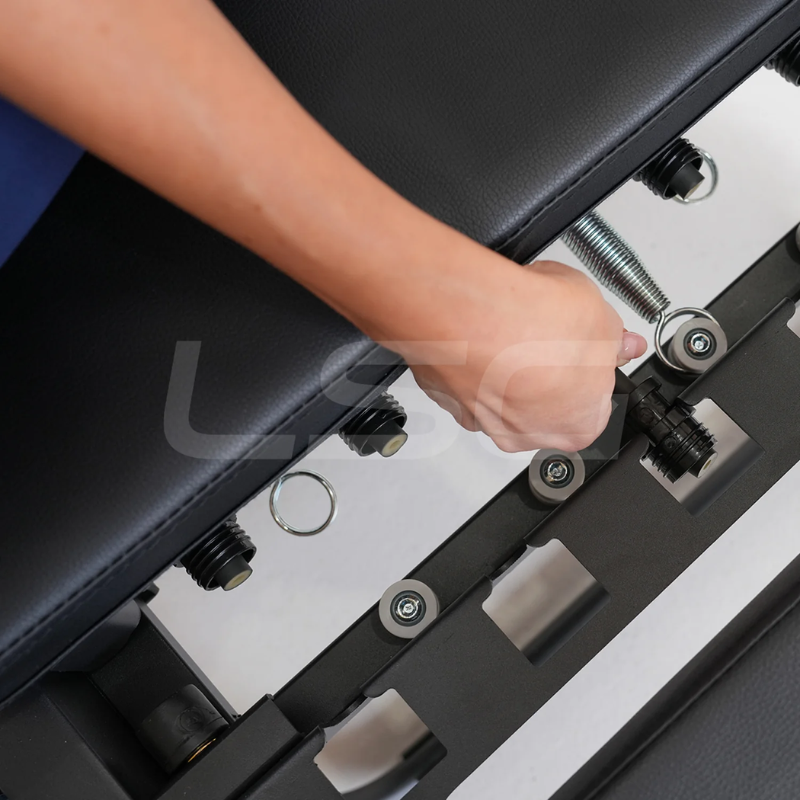 Person adjusting a spring on the LSG GPR100 Foldable Pilates Reformer Machine