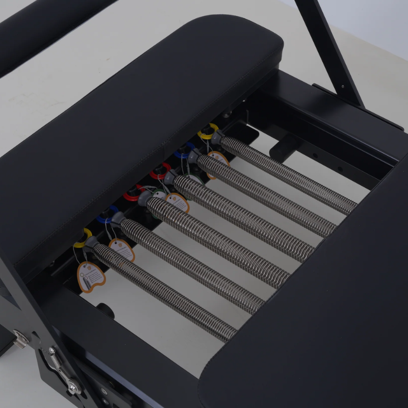 Close-up of springs on Milaron Pearl V3 Folding Pilates Reformer in Noir