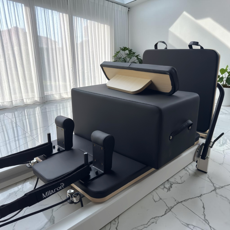 Closer view of all included accessories with standing platform facing back for Milaron Pearl V3 Studio Reformer in Original