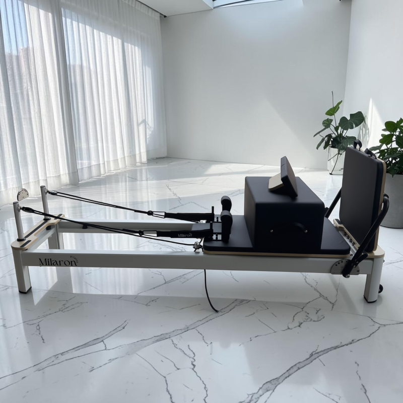 Pilates box and standing platform sitting on the carriage of Milaron Pearl V3 Studio Reformer Pilates Machine in Original