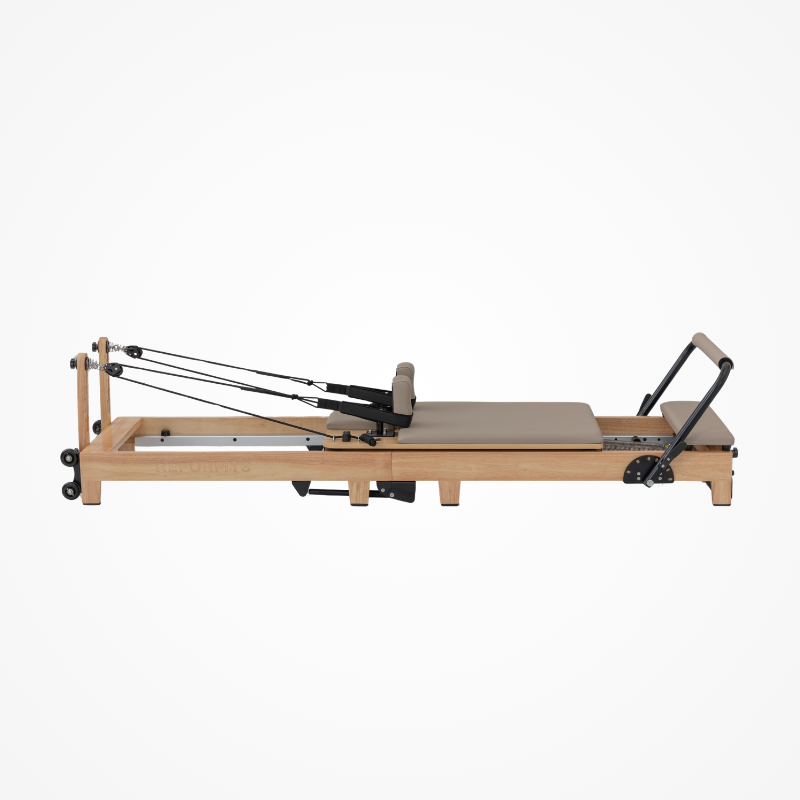 Right side view of the Reformys Cloud Folding Pilates Reformer Machine in Beige without jumpboard