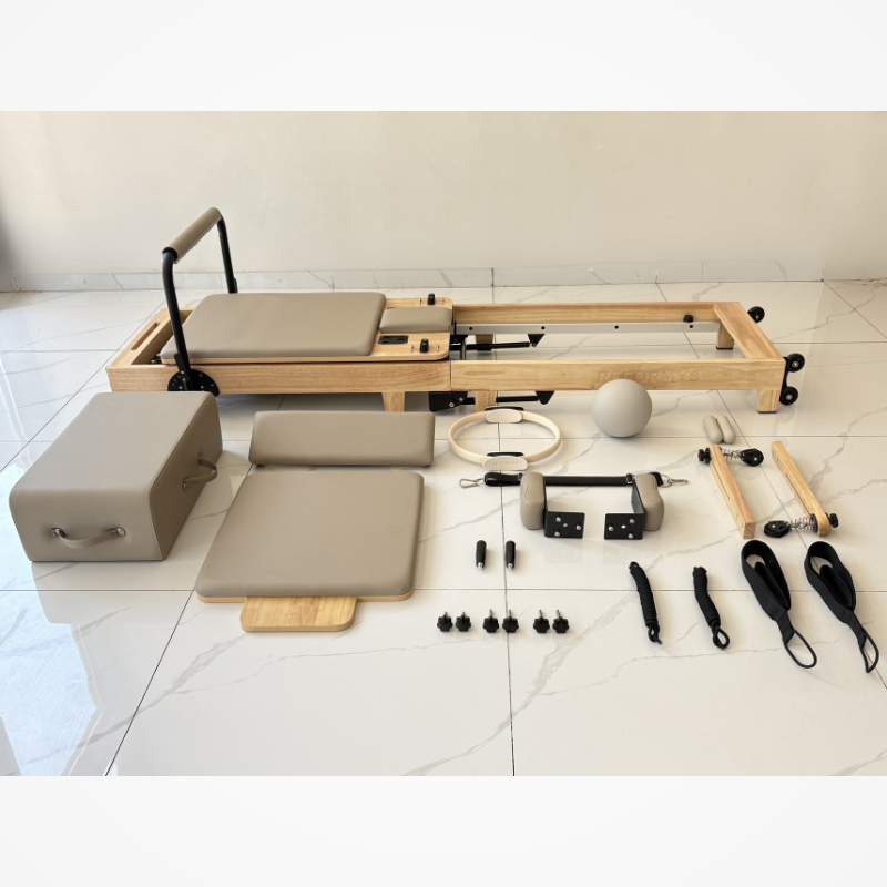 Flat lay of all Pilates accessories and parts included in the Reformys Cloud Folding Pilates Reformer Set in Beige