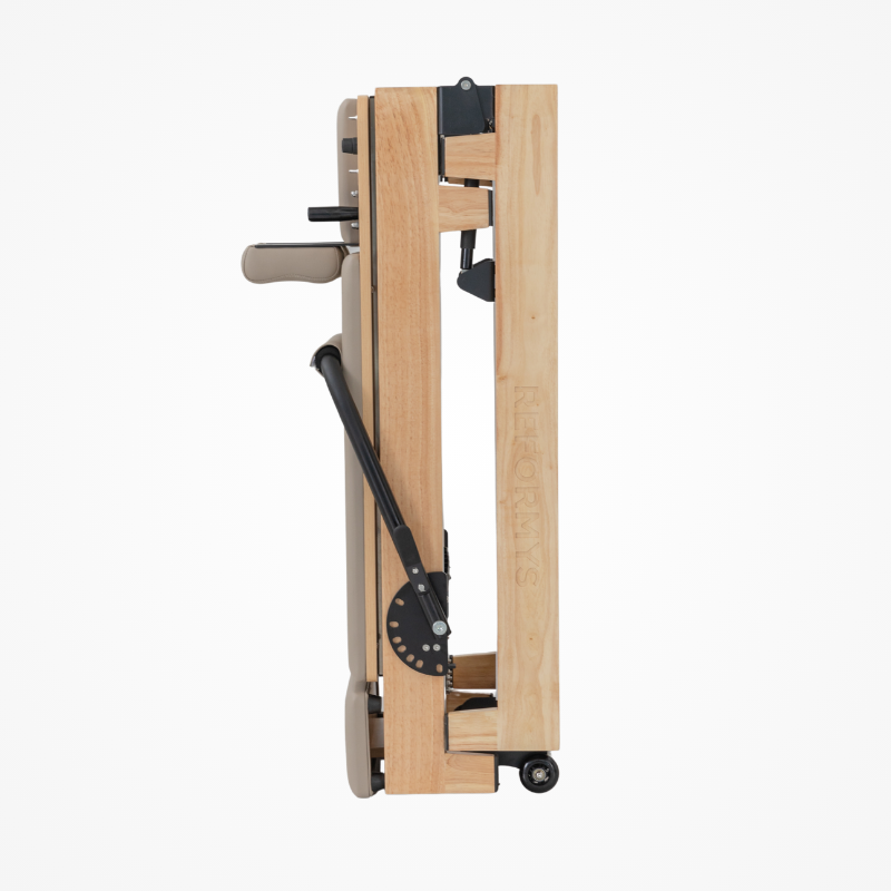 Side view of the Reformys Cloud Portable Pilates Reformer in Beige in folded position
