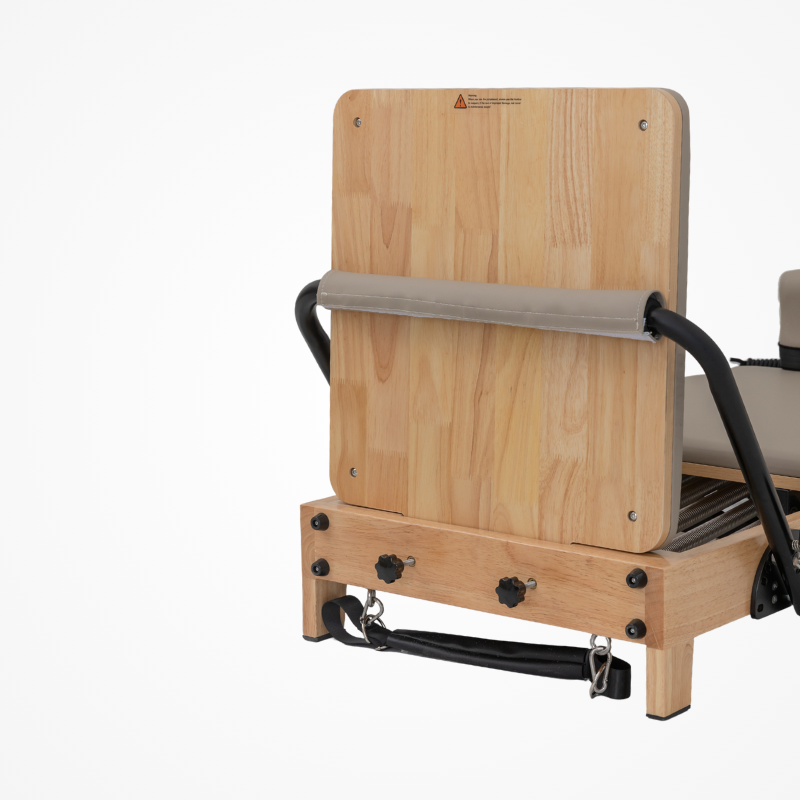 Front view of the Reformys Cloud Folding Pilates Reformer in Beige with jumpboard on