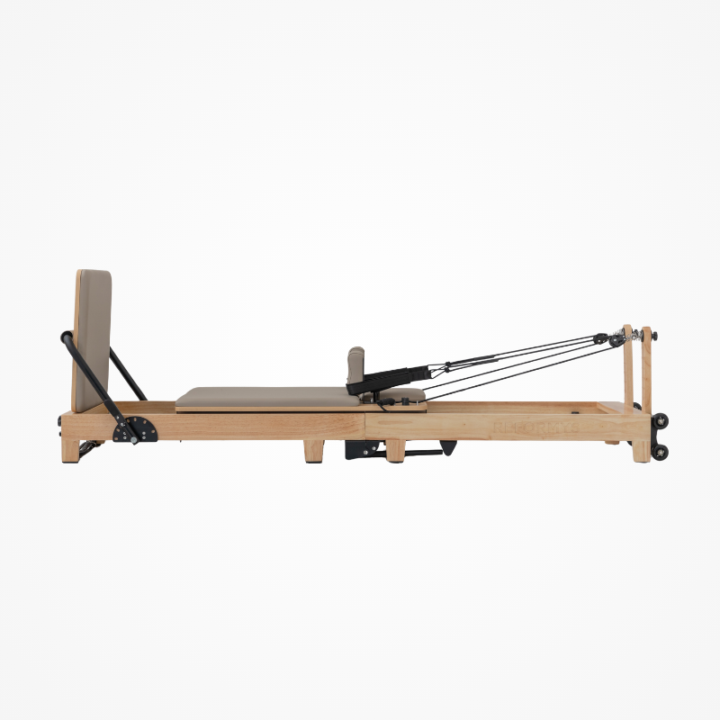 Left side view of the Reformys Cloud Folding Pilates Reformer Machine in Beige