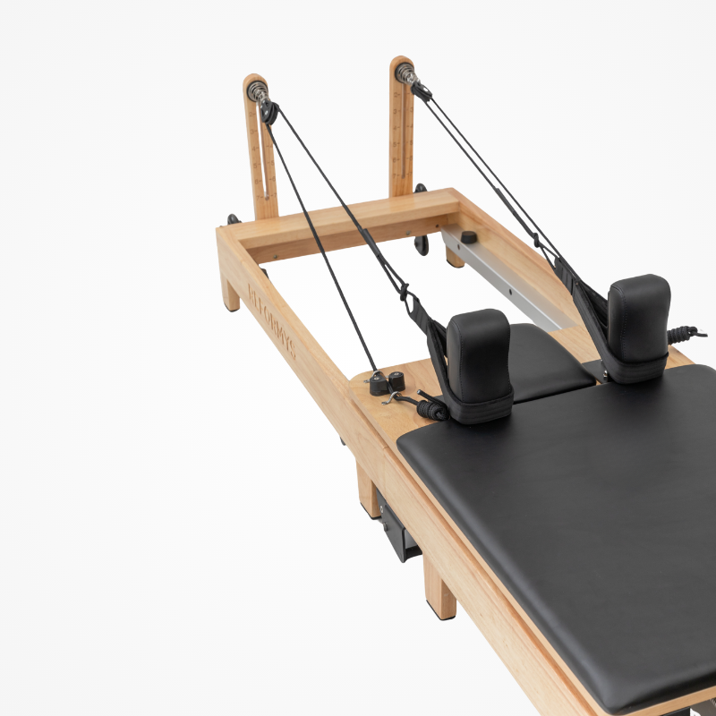 Closer view of the double-loop handles, rope and carriage on the Reformys Cloud Folding Pilates Reformer Machine in Black