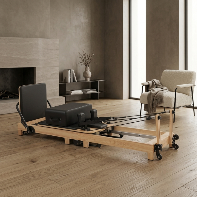 Reformys Cloud Hydraulic-Assisted Folding Pilates Reformer Machine in Black inside a luxurious home lounge