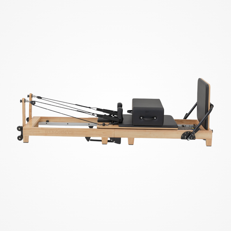 Right side view of Reformys Cloud Foldable Pilates Reformer in Black with jumpboard