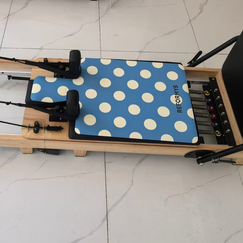 Reformys Pilates Reformer Mat in Ocean Dot on a Pilates reformer machine