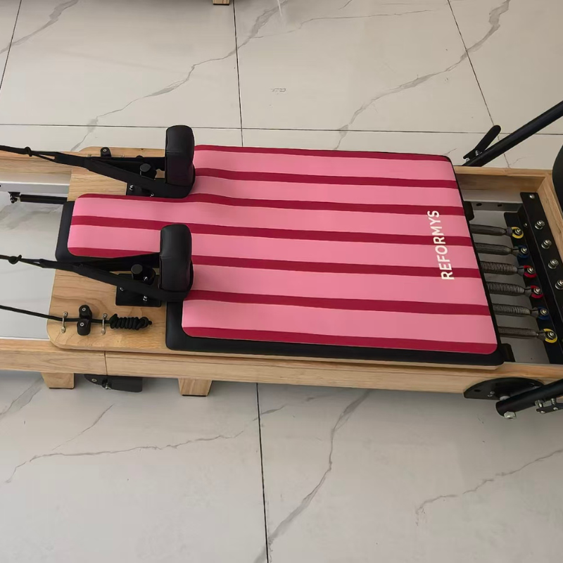 Closer view of the Reformys Pilates Reformer Mat in Sweet Rebel on a Pilates reformer machine