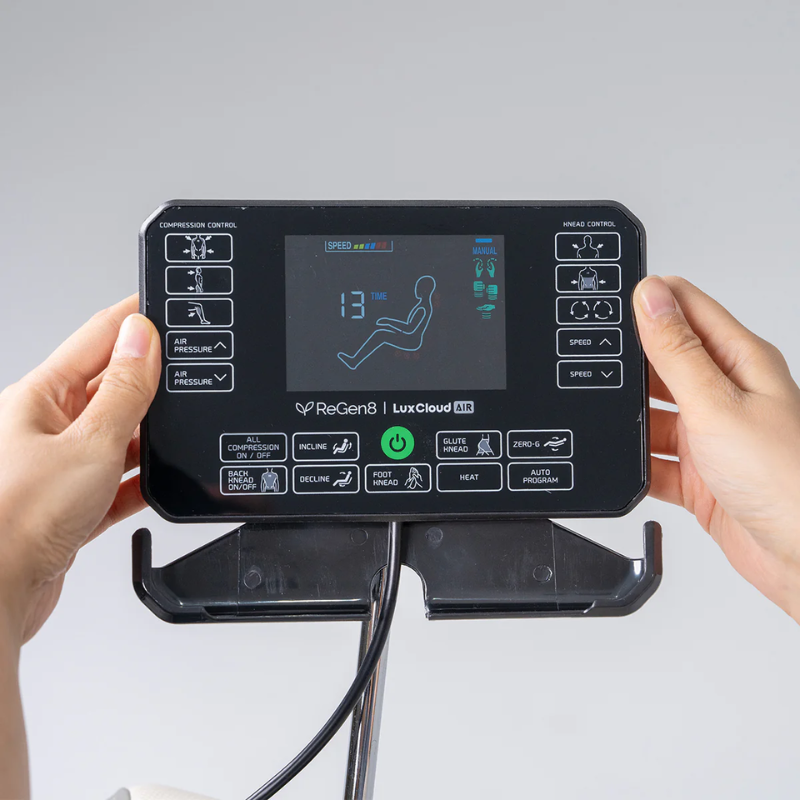 Close-up of hands holding the control screen panel on the ReGen8 LuxCloud Air Zero Gravity Heated Massage Chair