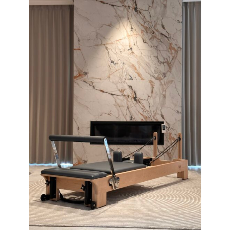 Volt Q2 Maple Wood Studio Pilates Reformer in a luxury home with marble wall