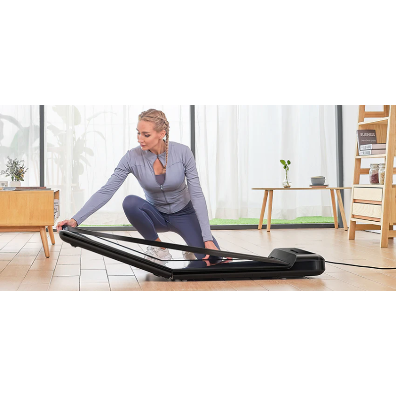 Woman folding up the WalkingPad C2 Compact Folding Treadmill