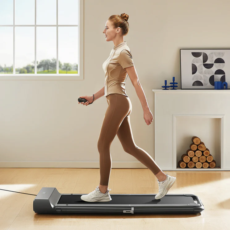 A woman walking on her Kingsmith Walkingpad R1 Pro in her lounge